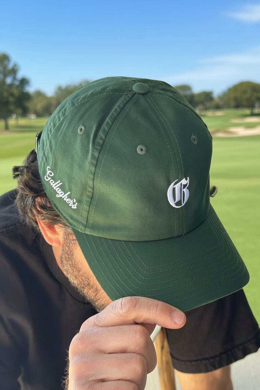 Man at golf course in a trendy branded golf hat that is branded for a seasonal on point fashion statement ideal for elevating the status of the golf course and golf club.